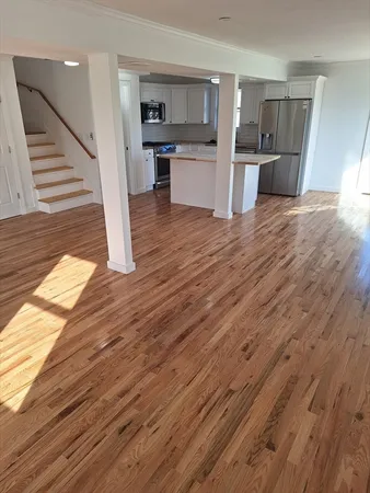 a view of kitchen with granite countertop cabinets and refrigerator