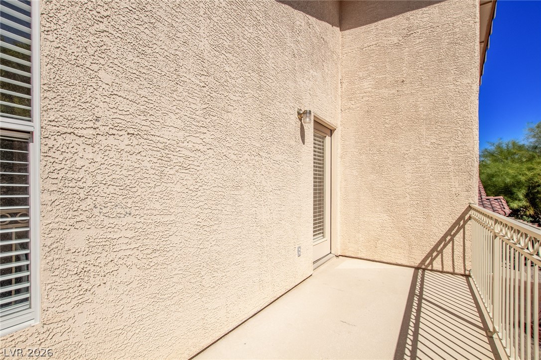 1477 Rancho Ridge Drive Henderson, NV 89012 - Photo 46 of 46 A private balcony extends from this textured stucco exterior, offering a quiet outdoor retreat.