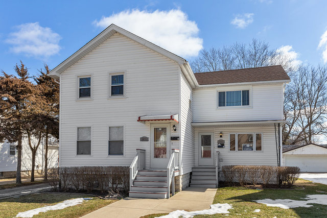 1431 Main Street Crete, IL 60417 - Photo 1 of 17 a front view of a house with a yard