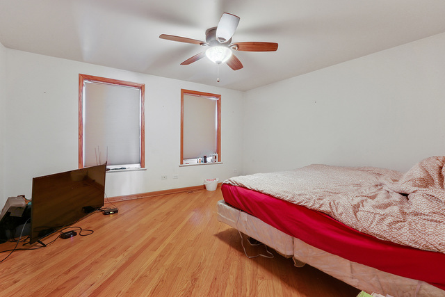 1431 Main Street Crete, IL 60417 - Photo 11 of 17 a bedroom with a bed and a flat screen tv