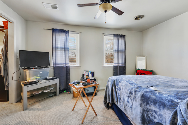 1431 Main Street Crete, IL 60417 - Photo 13 of 17 a bedroom with a bed and a flat screen tv