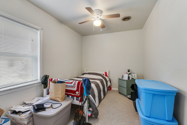 1431 Main Street Crete, IL 60417 - Photo 14 of 17 a bed room with a bed and a chandelier