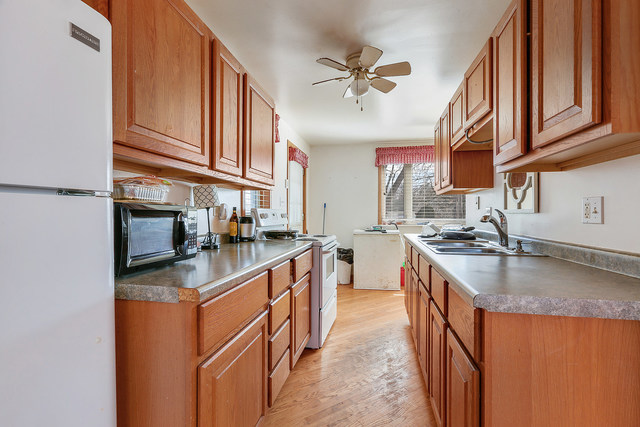 1431 Main Street Crete, IL 60417 - Photo 6 of 17 a kitchen with stainless steel appliances granite countertop a sink stove and refrigerator