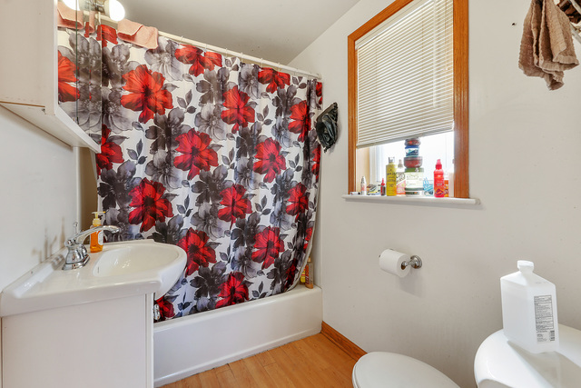 1431 Main Street Crete, IL 60417 - Photo 7 of 17 a bathroom with a sink toilet and mirror