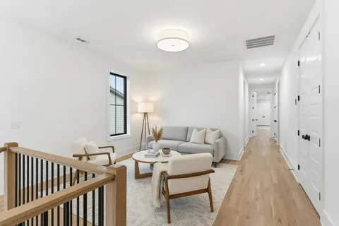 a bedroom with a bed a mirror and lamp