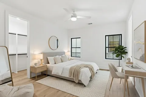 a bedroom with bed and a large window