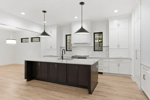 a kitchen with cabinets and window