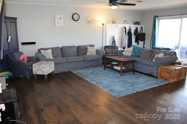 a dining room with furniture and a potted plant