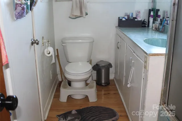 a bathroom with a toilet a sink and a window