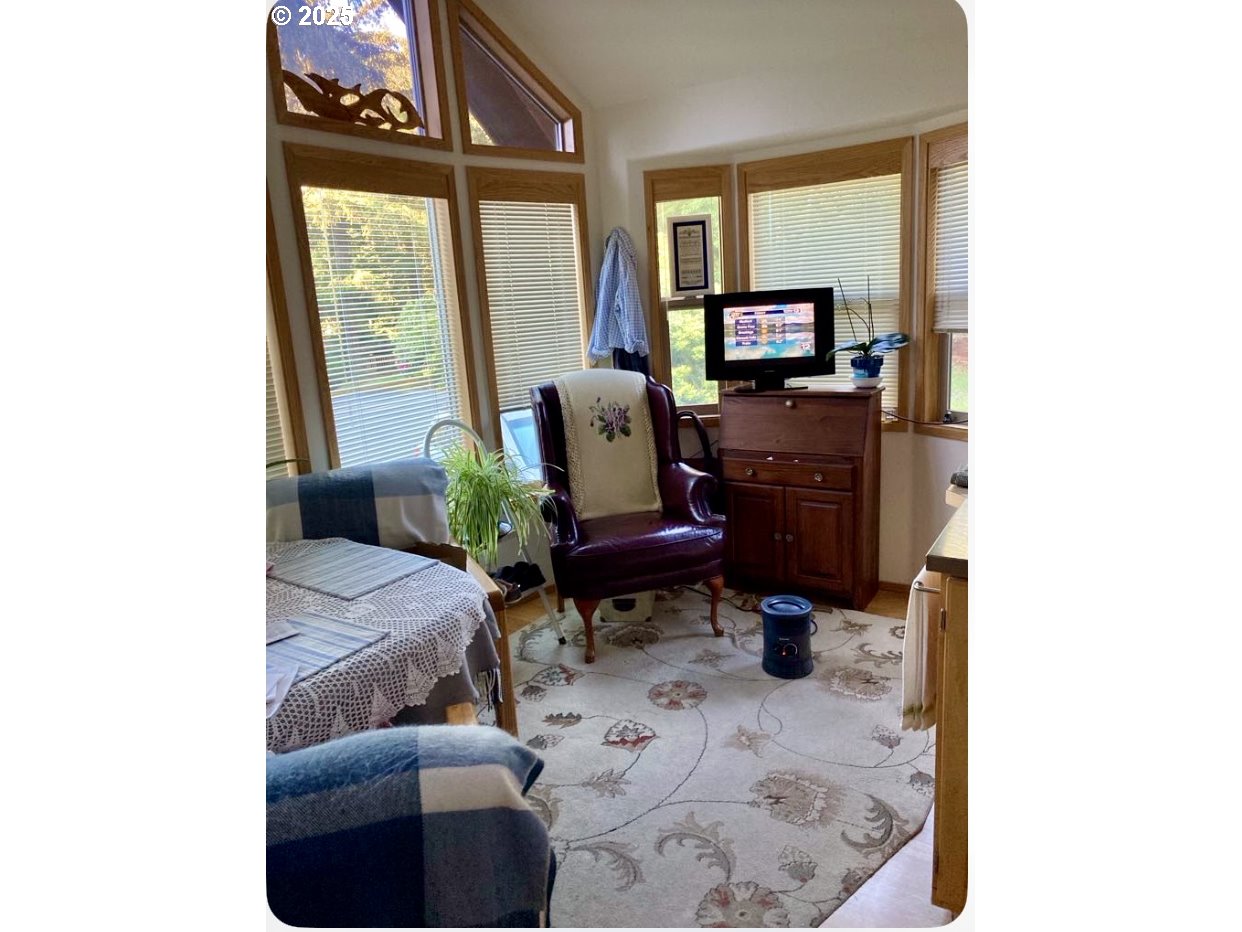 19921 Whaleshead Road, Unit B2 Brookings, OR 97415 - Photo 13 of 41 a living room with furniture and a flat screen tv