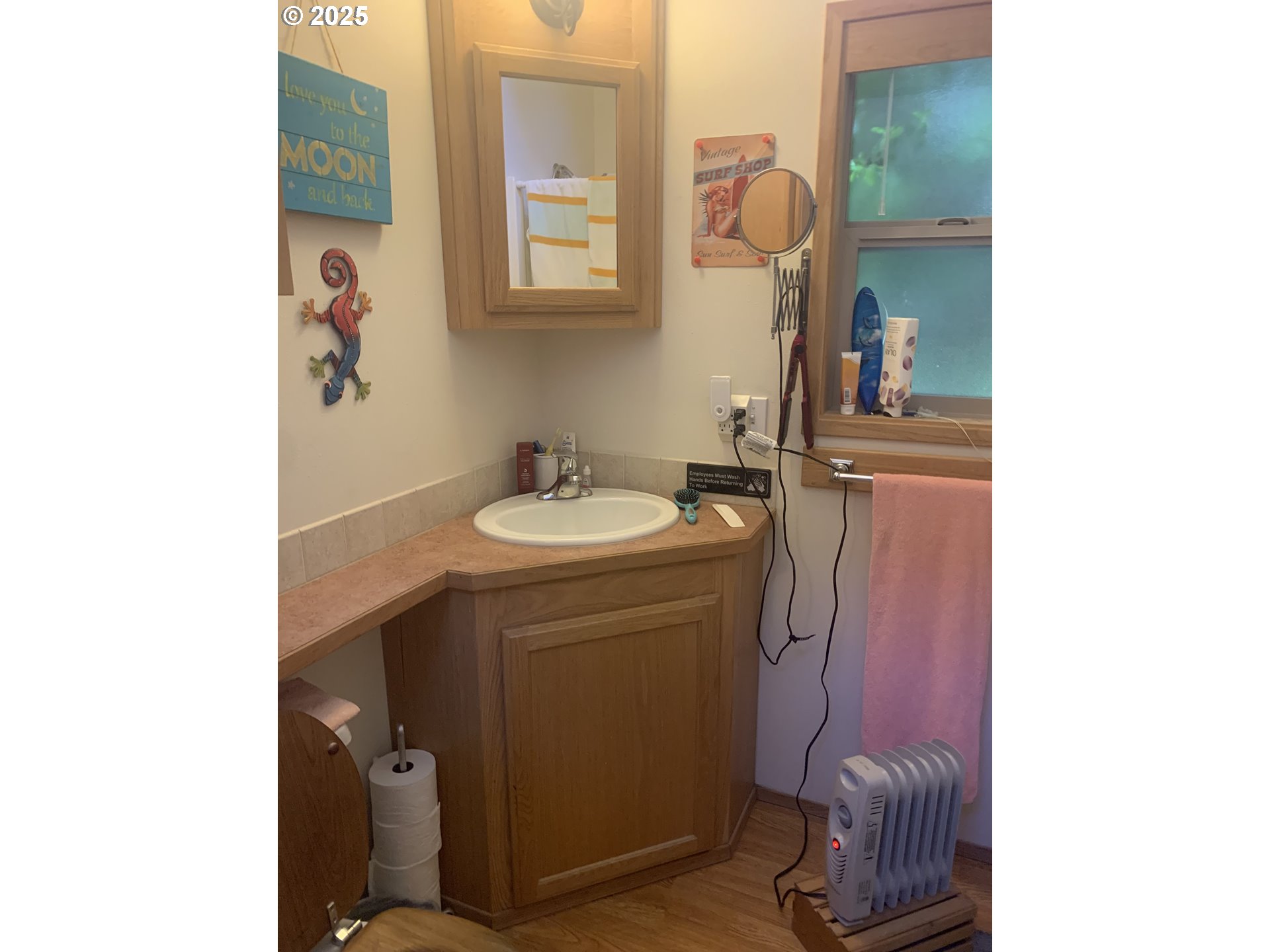 19921 Whaleshead Road, Unit B2 Brookings, OR 97415 - Photo 15 of 41 a bathroom with a sink a toilet and mirror