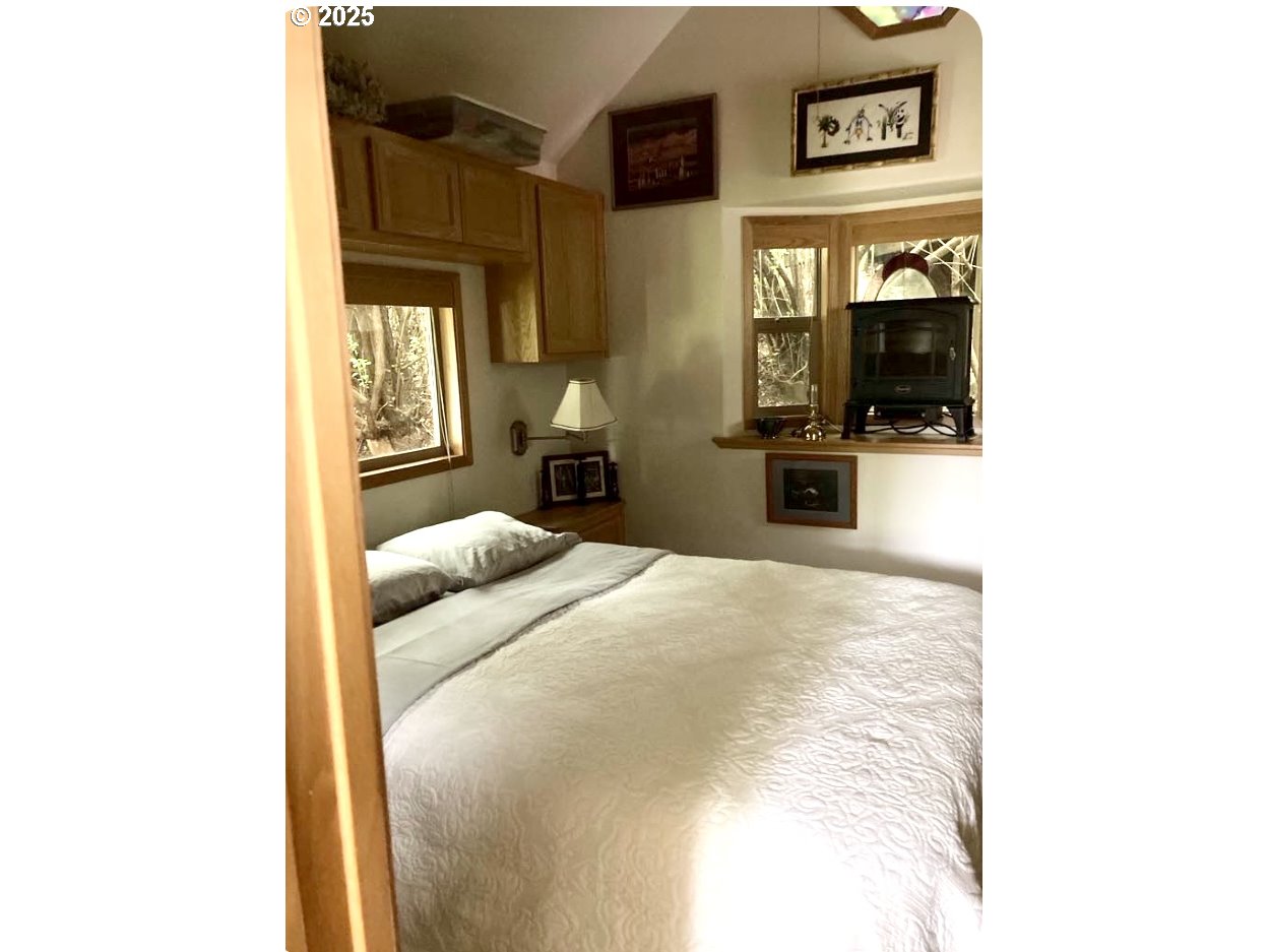 19921 Whaleshead Road, Unit B2 Brookings, OR 97415 - Photo 18 of 41 a bedroom with a bed and a television