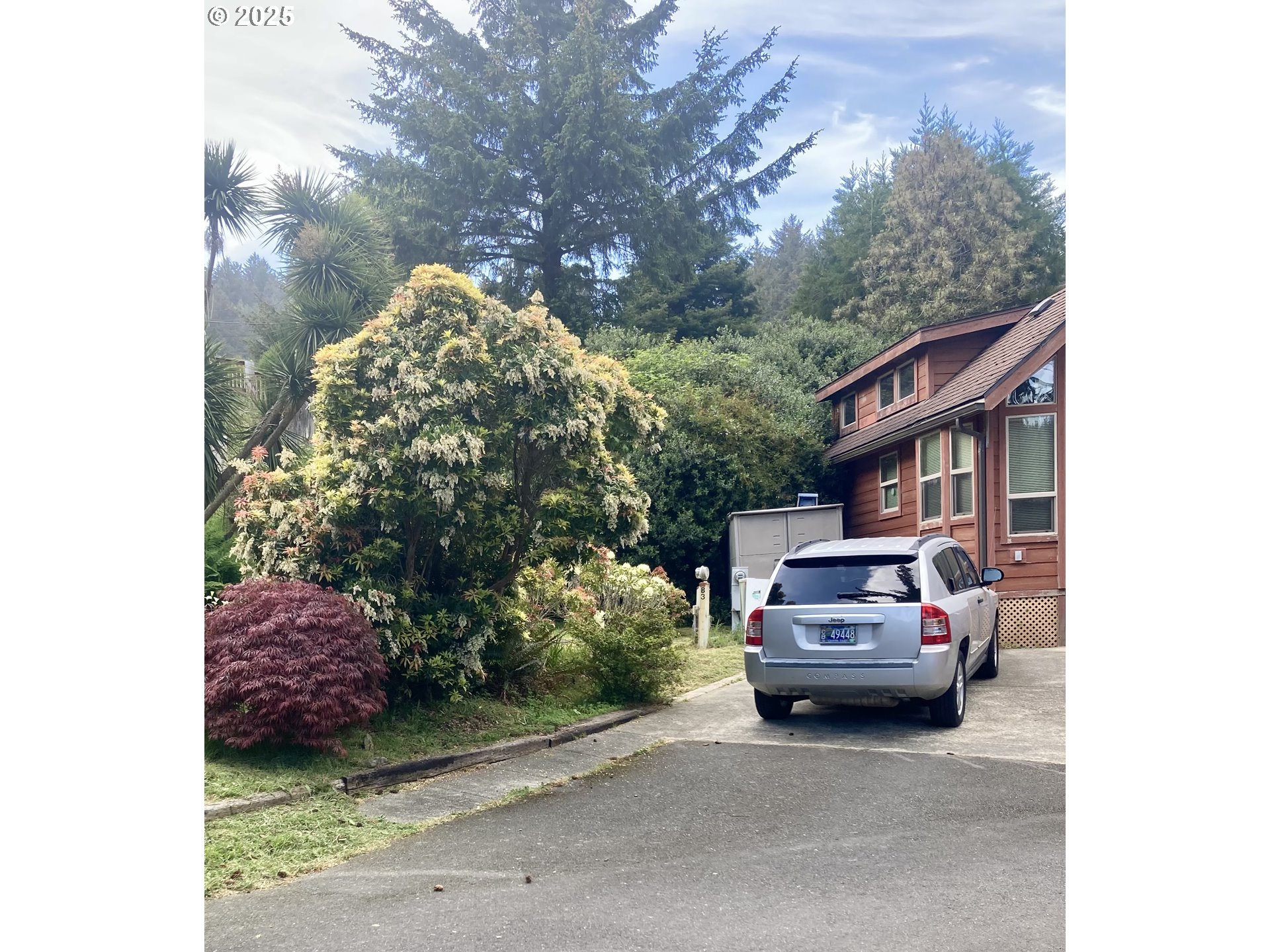 19921 Whaleshead Road, Unit B2 Brookings, OR 97415 - Photo 4 of 41 a view of a car parked in back yard of a house