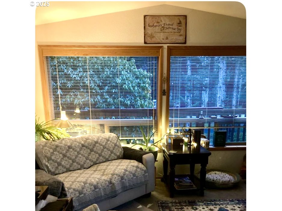 19921 Whaleshead Road, Unit B2 Brookings, OR 97415 - Photo 6 of 41 a living room with furniture and a floor to ceiling window