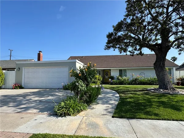 a front view of a house with a yard and a garage