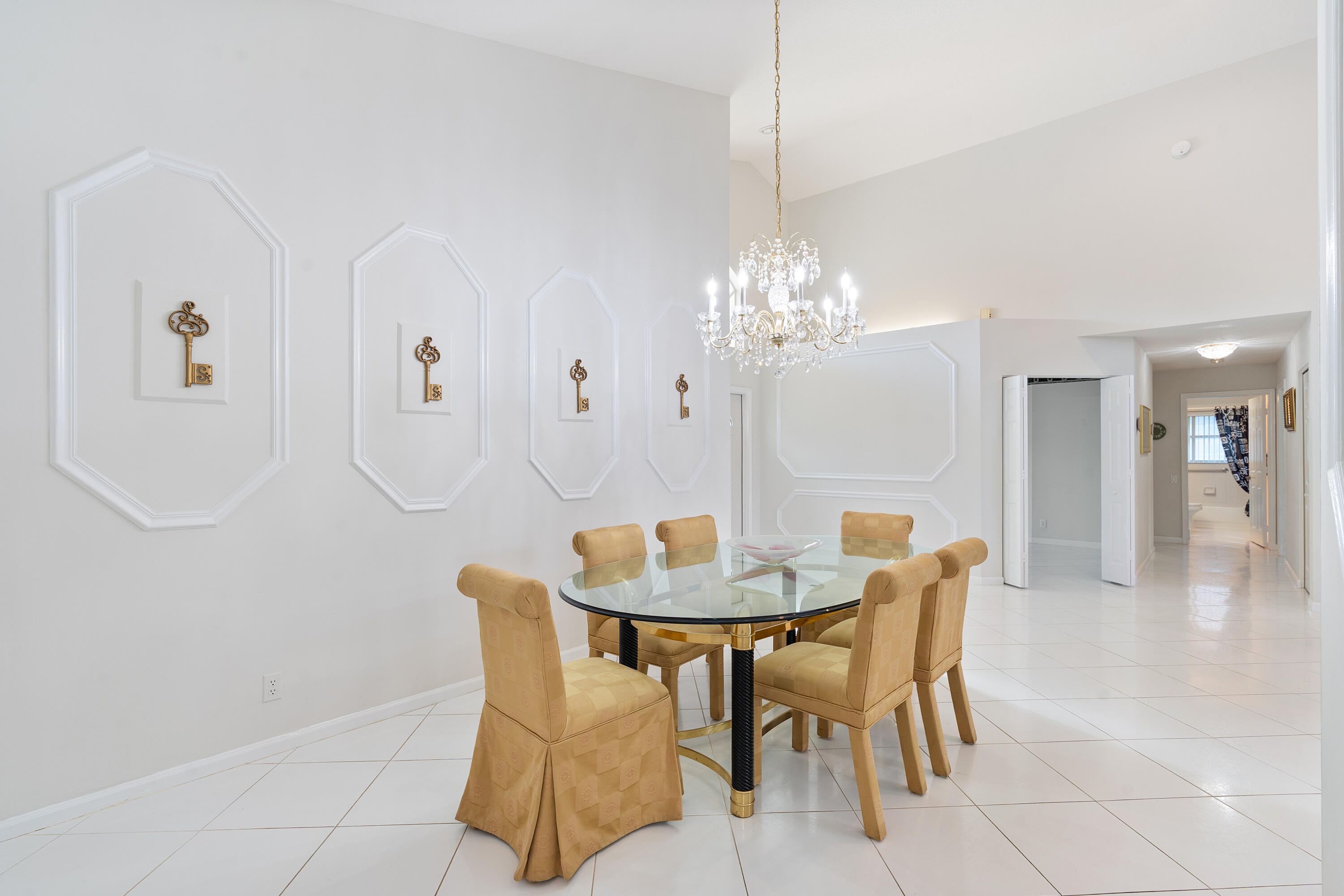 7291 Falls Road East Boynton Beach, FL 33437 - Photo 12 of 26 a dining room with furniture and chandelier