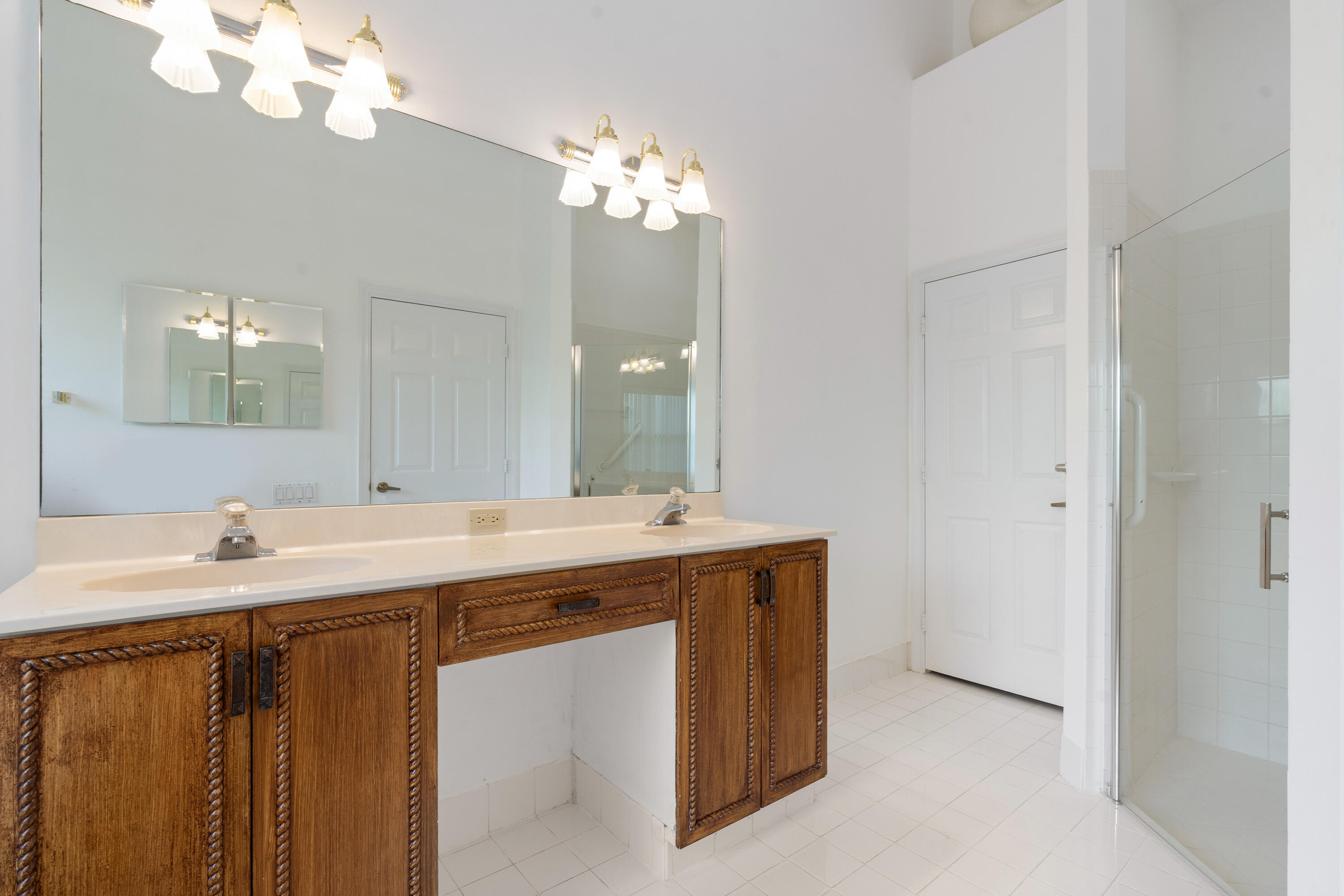 7291 Falls Road East Boynton Beach, FL 33437 - Photo 21 of 26 a bathroom with a sink vanity and a mirror