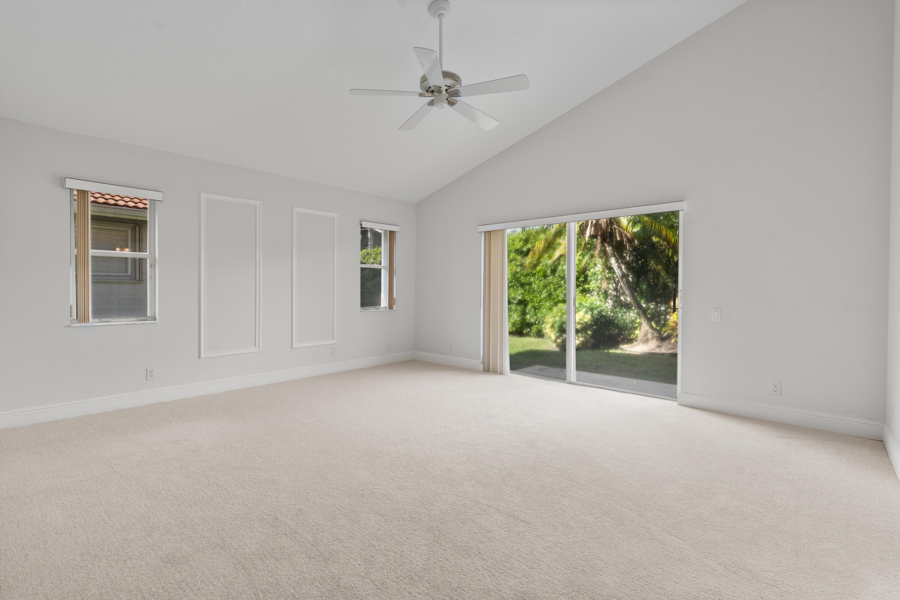 7291 Falls Road East Boynton Beach, FL 33437 - Photo 25 of 26 a view of a big room with windows and chandelier fan