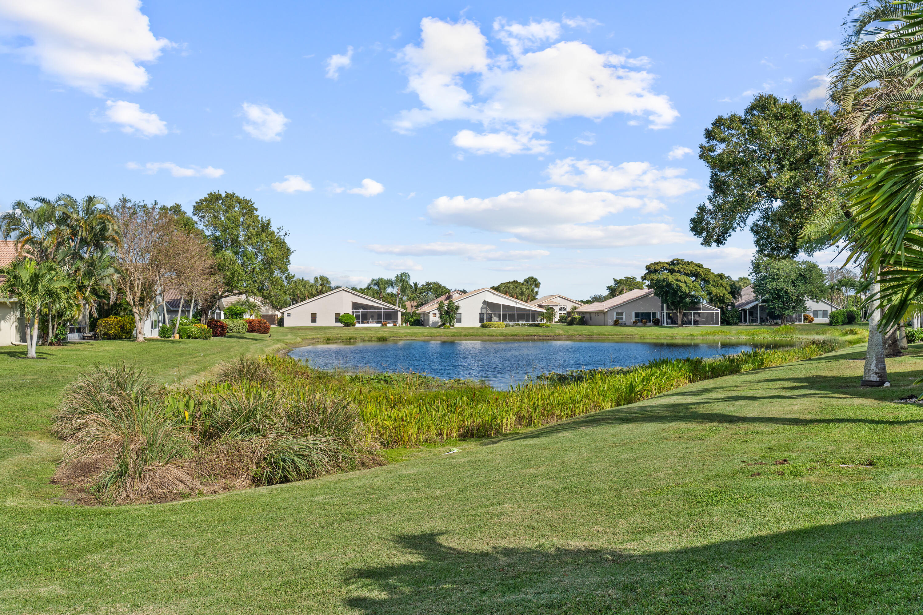 7291 Falls Road East Boynton Beach, FL 33437 - Photo 3 of 26 a view of a golf course with a lake