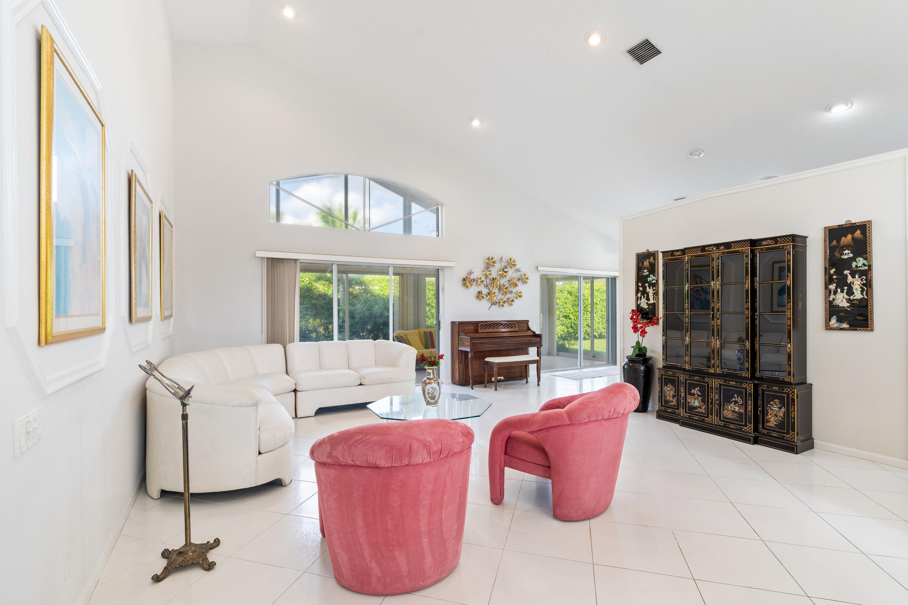 7291 Falls Road East Boynton Beach, FL 33437 - Photo 4 of 26 a living room with furniture a flat screen tv and large window