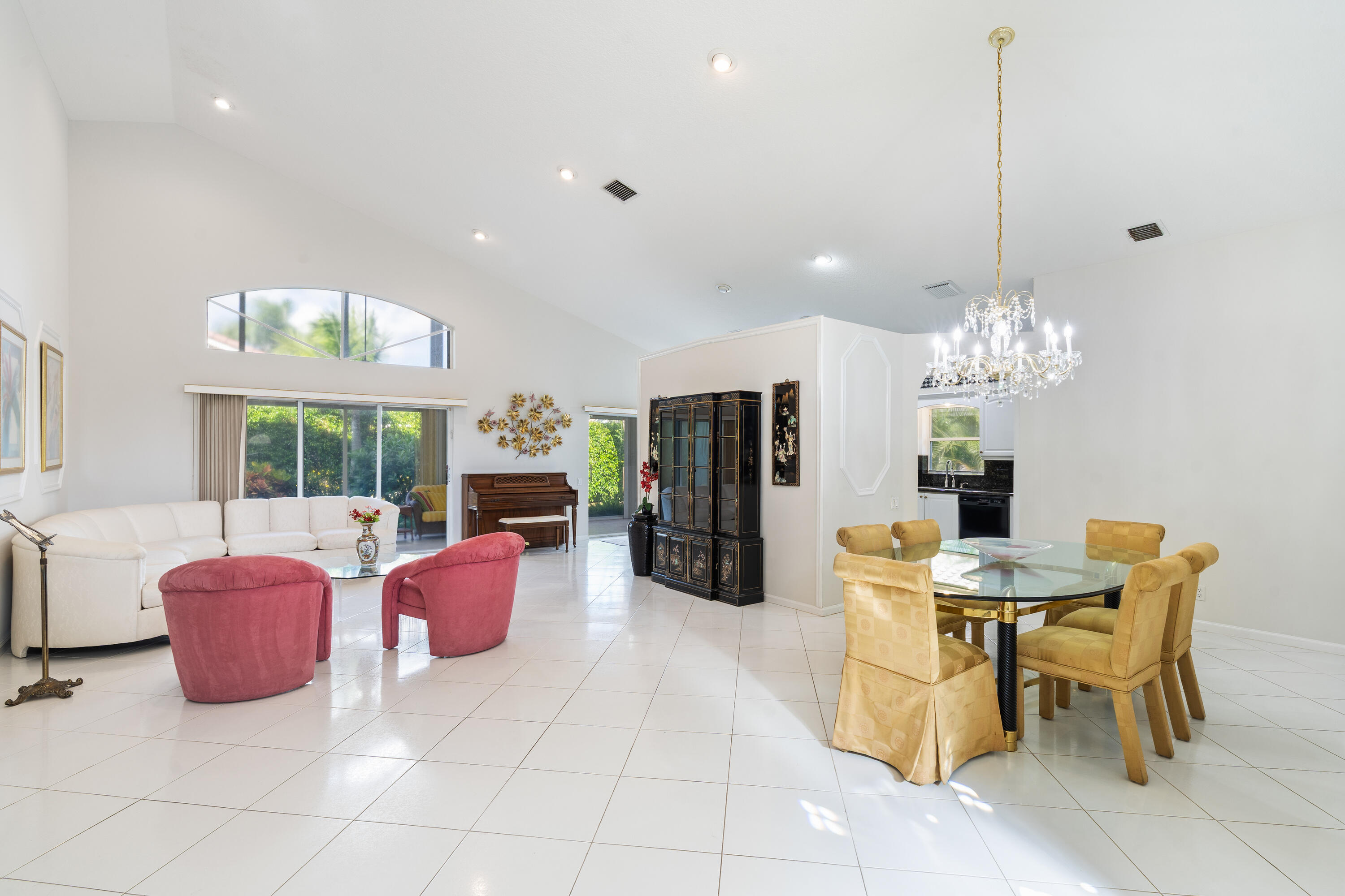 7291 Falls Road East Boynton Beach, FL 33437 - Photo 6 of 26 a dining room with furniture a chandelier and window