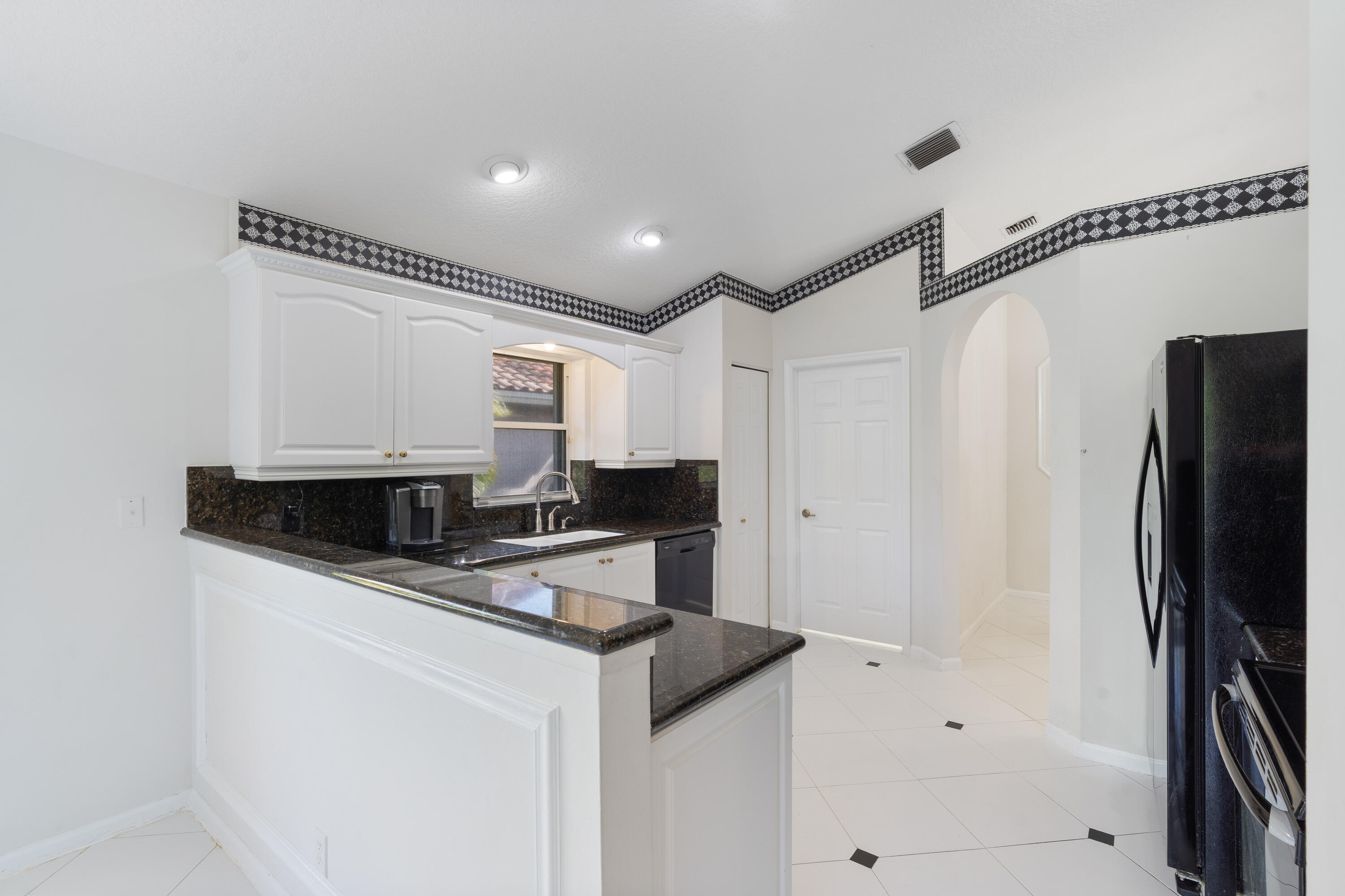 7291 Falls Road East Boynton Beach, FL 33437 - Photo 9 of 26 a kitchen with stainless steel appliances a microwave a sink and refrigerator