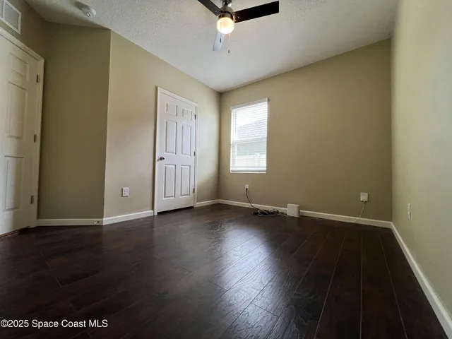 an empty room with wooden floor and window