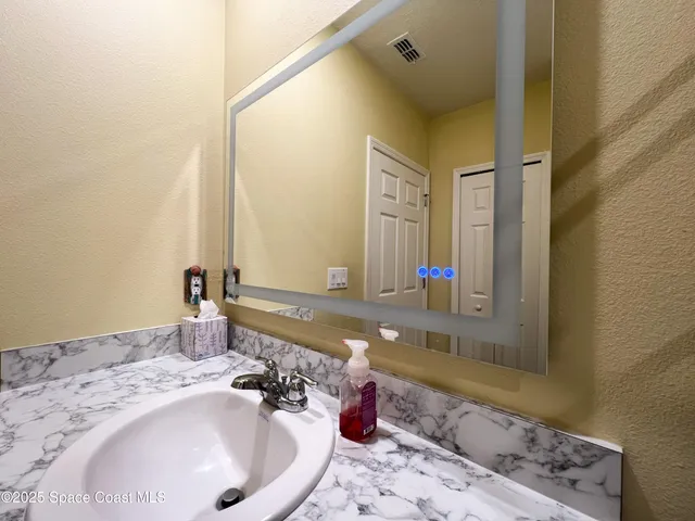 a bathroom with a tub sink and mirror