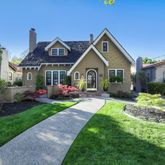 a front view of a house with yard and green space