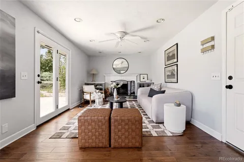 a living room with furniture a fireplace and a table