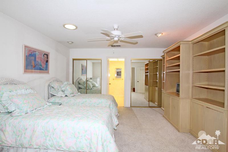 52 Maximo Way Palm Desert, CA 92260 - Photo 13 of 20 a spacious bedroom with a bed and a chandelier