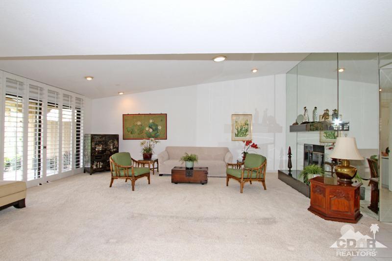 52 Maximo Way Palm Desert, CA 92260 - Photo 2 of 20 a living room with furniture and a fireplace