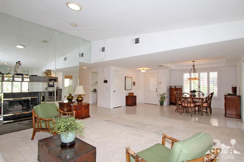 52 Maximo Way Palm Desert, CA 92260 - Photo 4 of 20 a living room with fireplace furniture and a large window