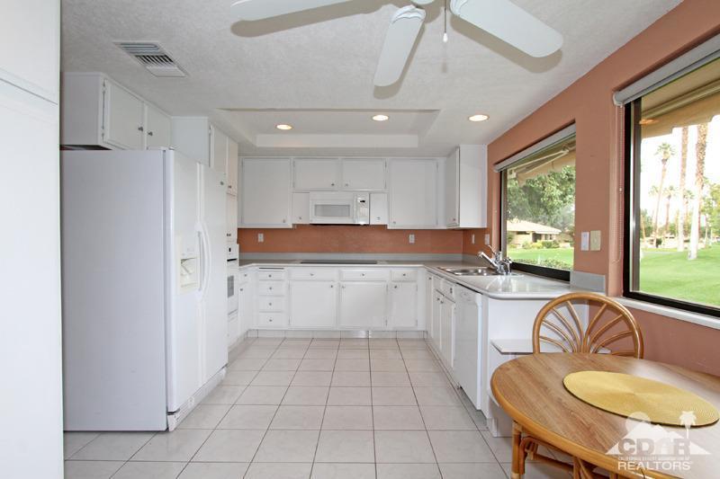 52 Maximo Way Palm Desert, CA 92260 - Photo 6 of 20 a kitchen with stainless steel appliances granite countertop a stove a sink and a refrigerator with wooden floor