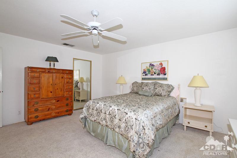52 Maximo Way Palm Desert, CA 92260 - Photo 10 of 20 a bedroom with a bed and a chandelier