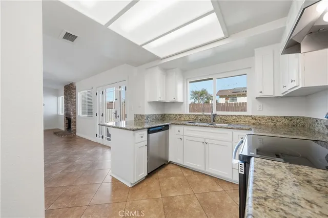 a kitchen with stainless steel appliances granite countertop a sink and cabinets