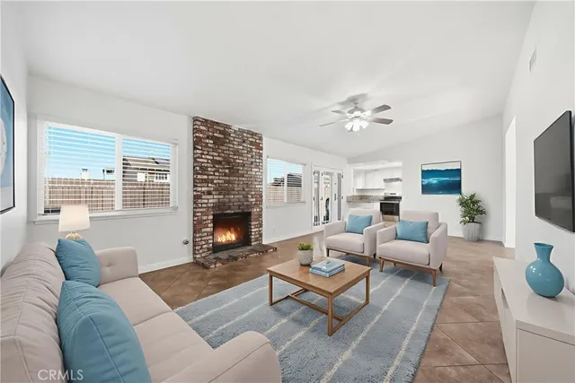 a living room with furniture fireplace and a large window