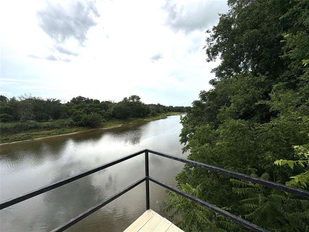 1170 Brazos Loop Gholson, TX 76705 - Photo 35 of 37 Outdoor platform featuring a black metal railing and wood-finish flooring