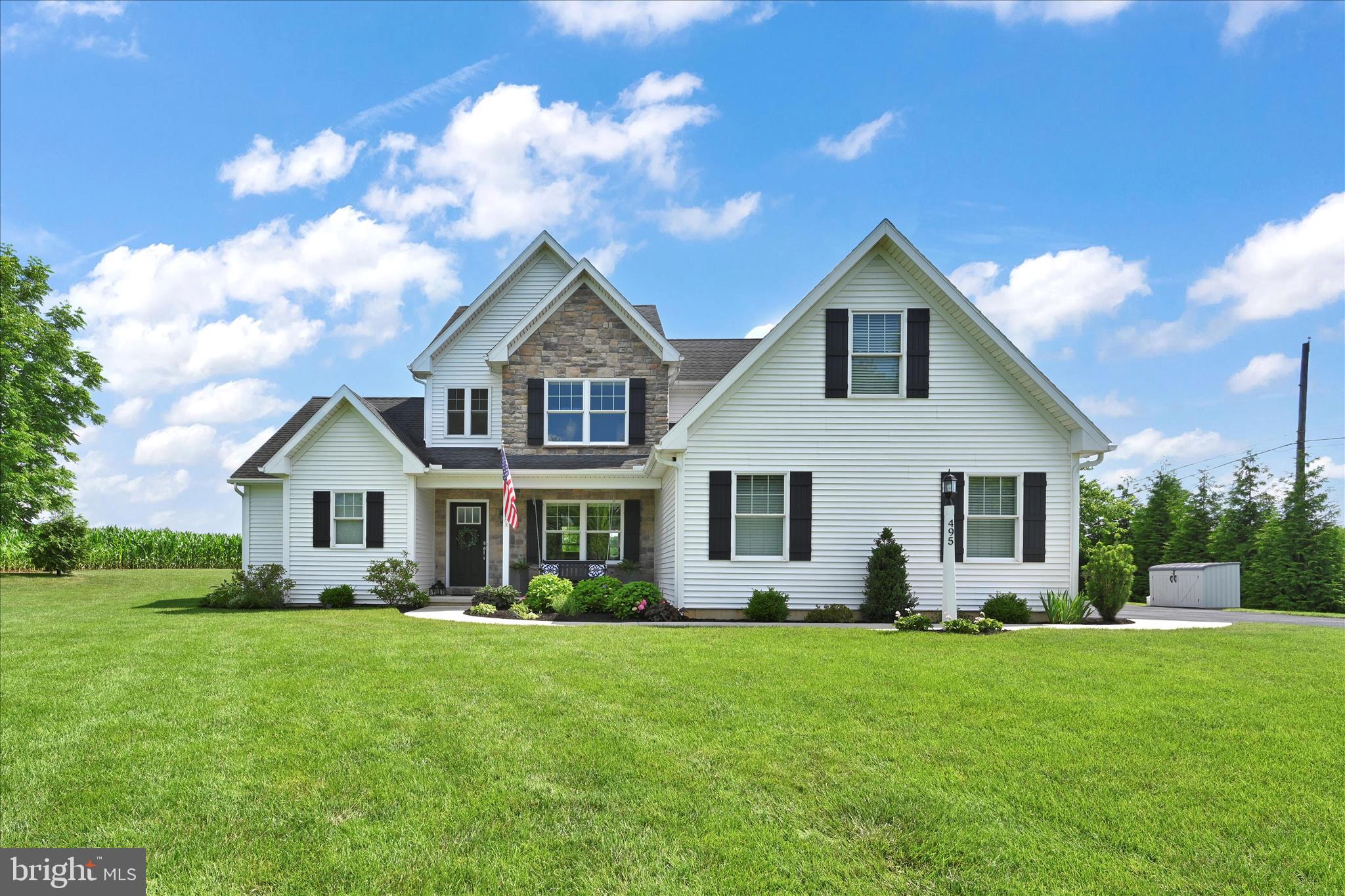 a front view of house with yard and green space