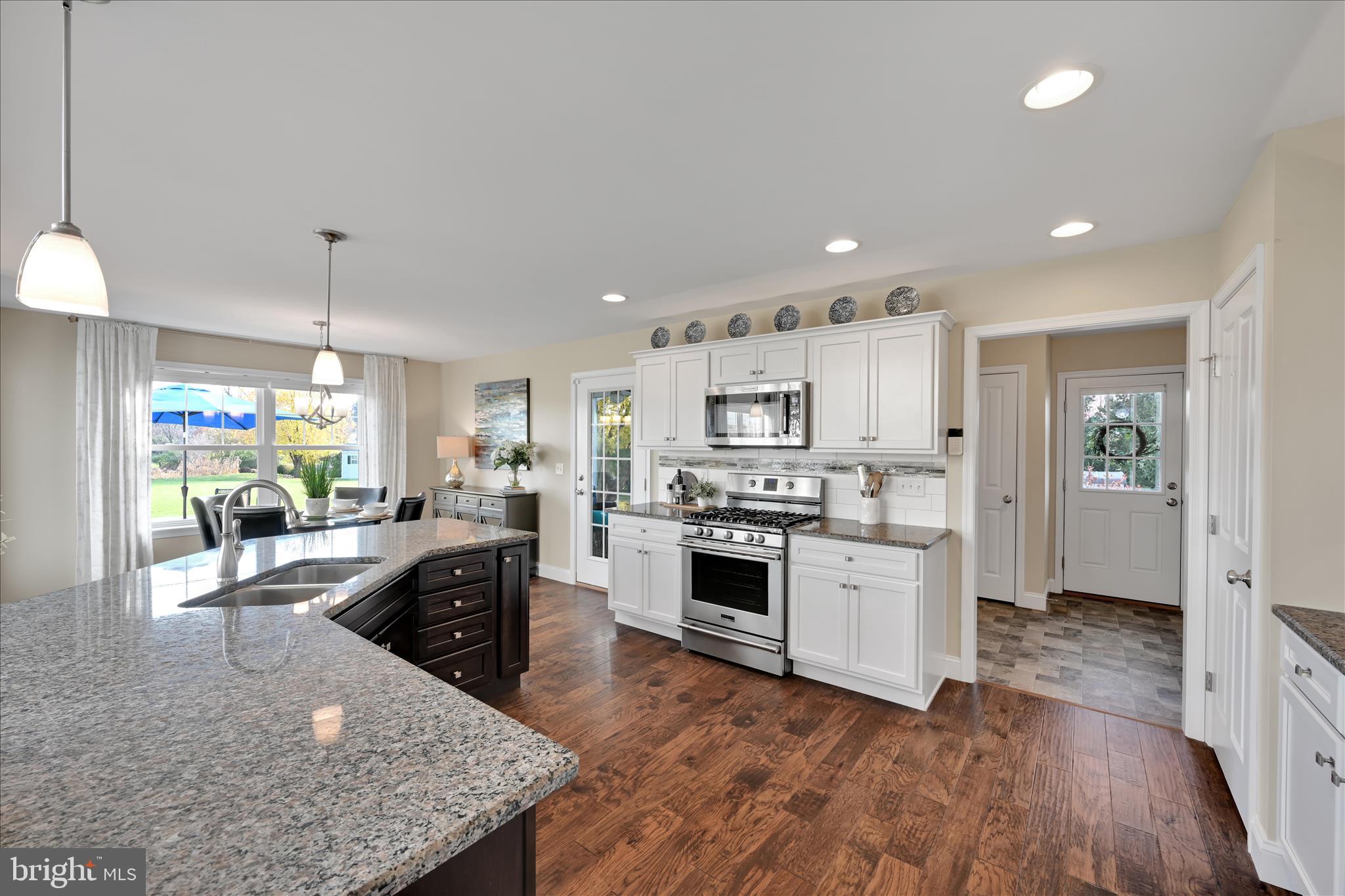 495 South Mill Street Lebanon, PA 17042 - Photo 10 of 54 a kitchen with stainless steel appliances granite countertop a refrigerator a stove top oven a sink dishwasher and white cabinets with wooden floor