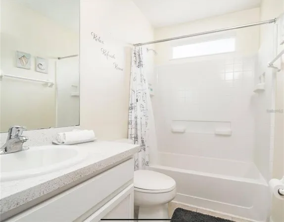 a bathroom with a bathtub shower sink vanity and toilet
