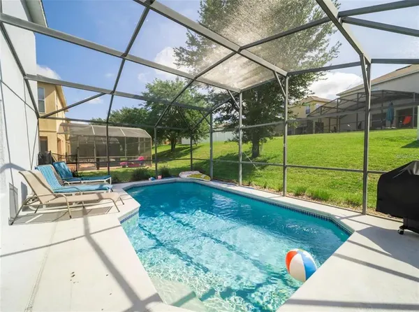 a view of a backyard with sitting area