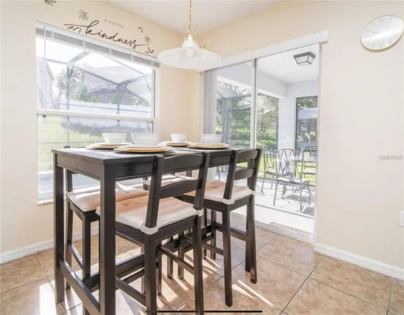 a dining room with furniture a chandelier and a rug