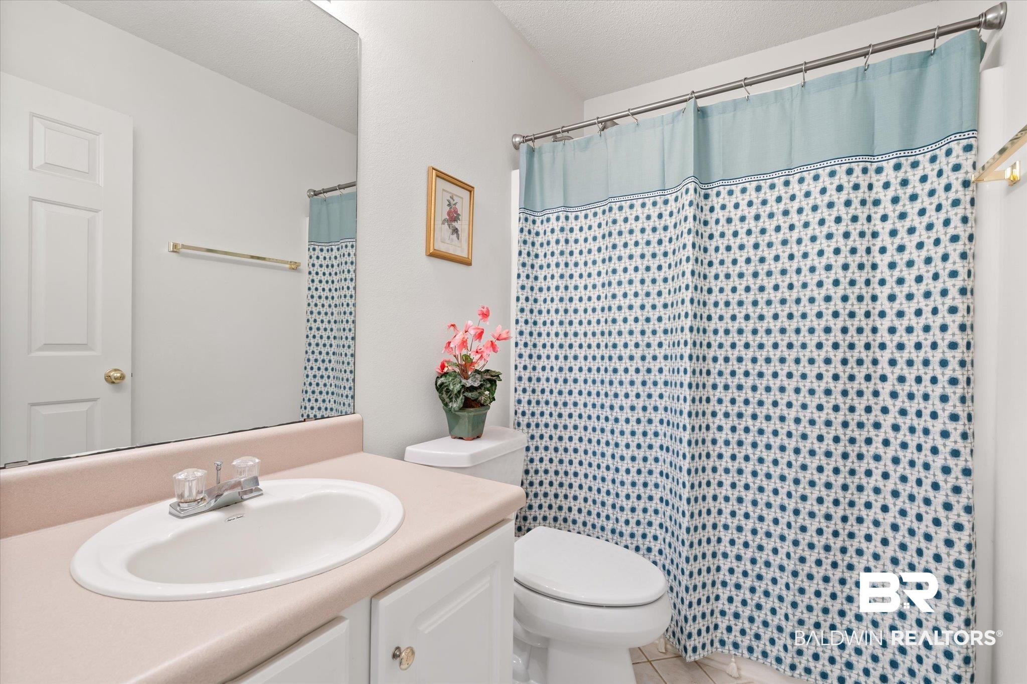 12520 Hunters Chase Foley, AL 36535 - Photo 27 of 32 Bathroom with a shower with shower curtain, toilet, vanity, and a textured ceiling