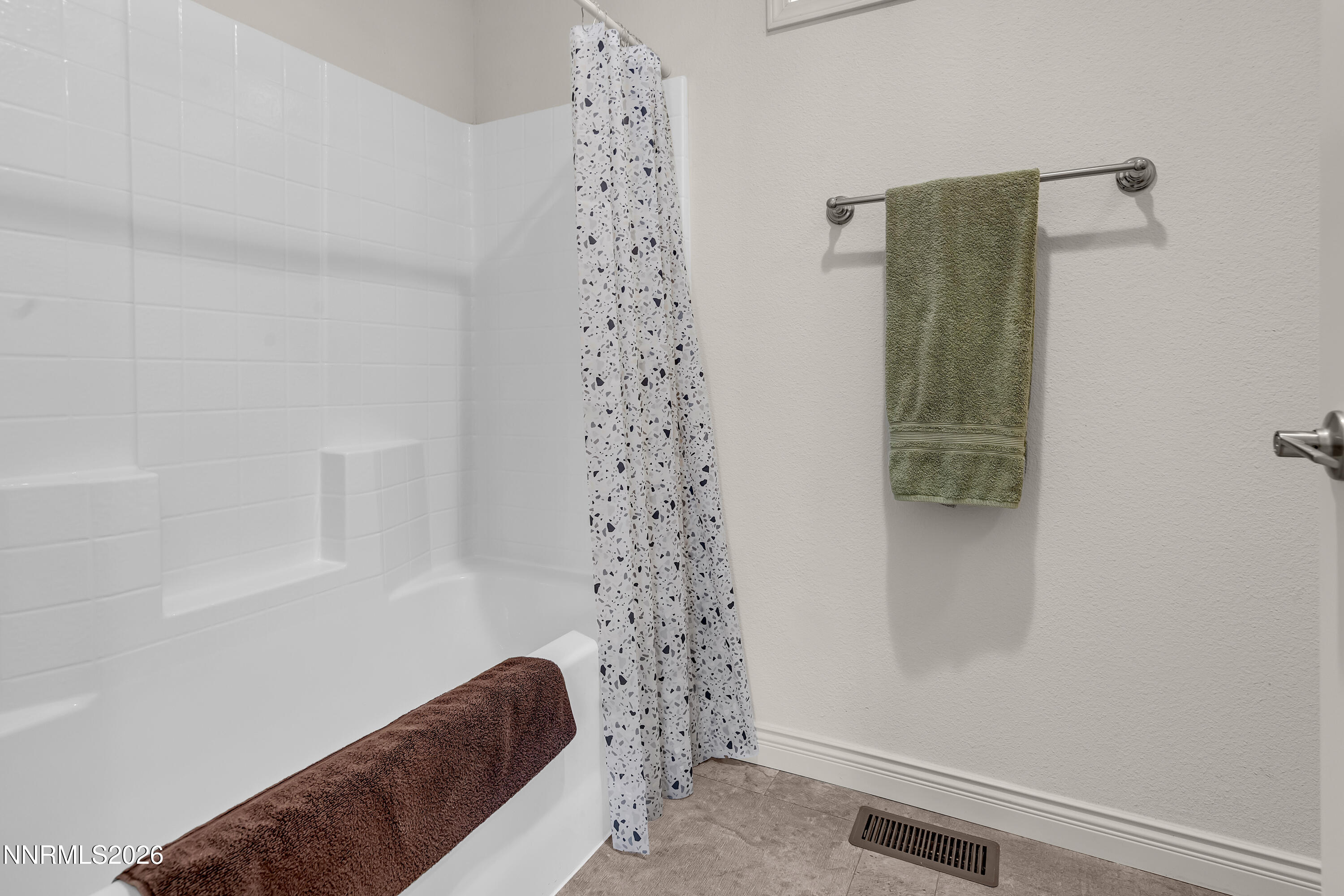 105 Arabian Way Reno, NV 89508 - Photo 24 of 40 a bathroom with a shower curtain and a shower curtain