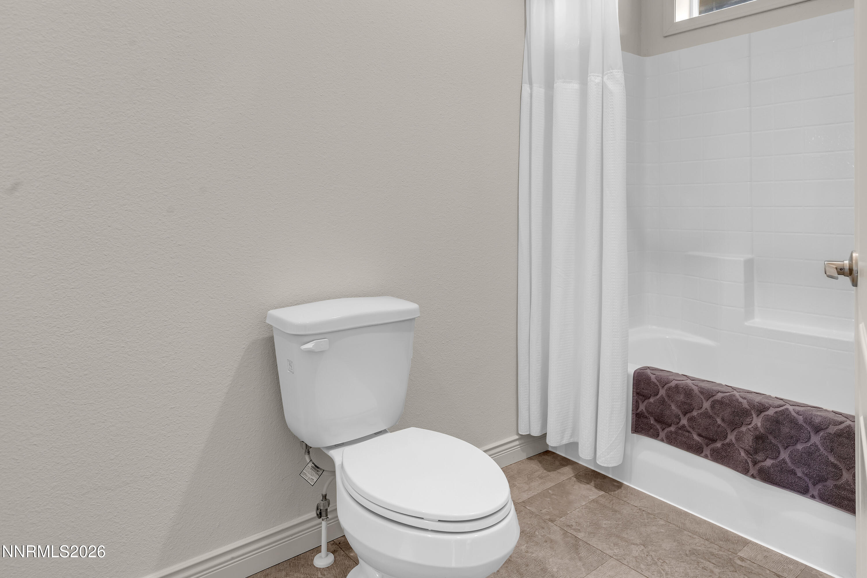 105 Arabian Way Reno, NV 89508 - Photo 30 of 40 a white toilet sitting next to a shower