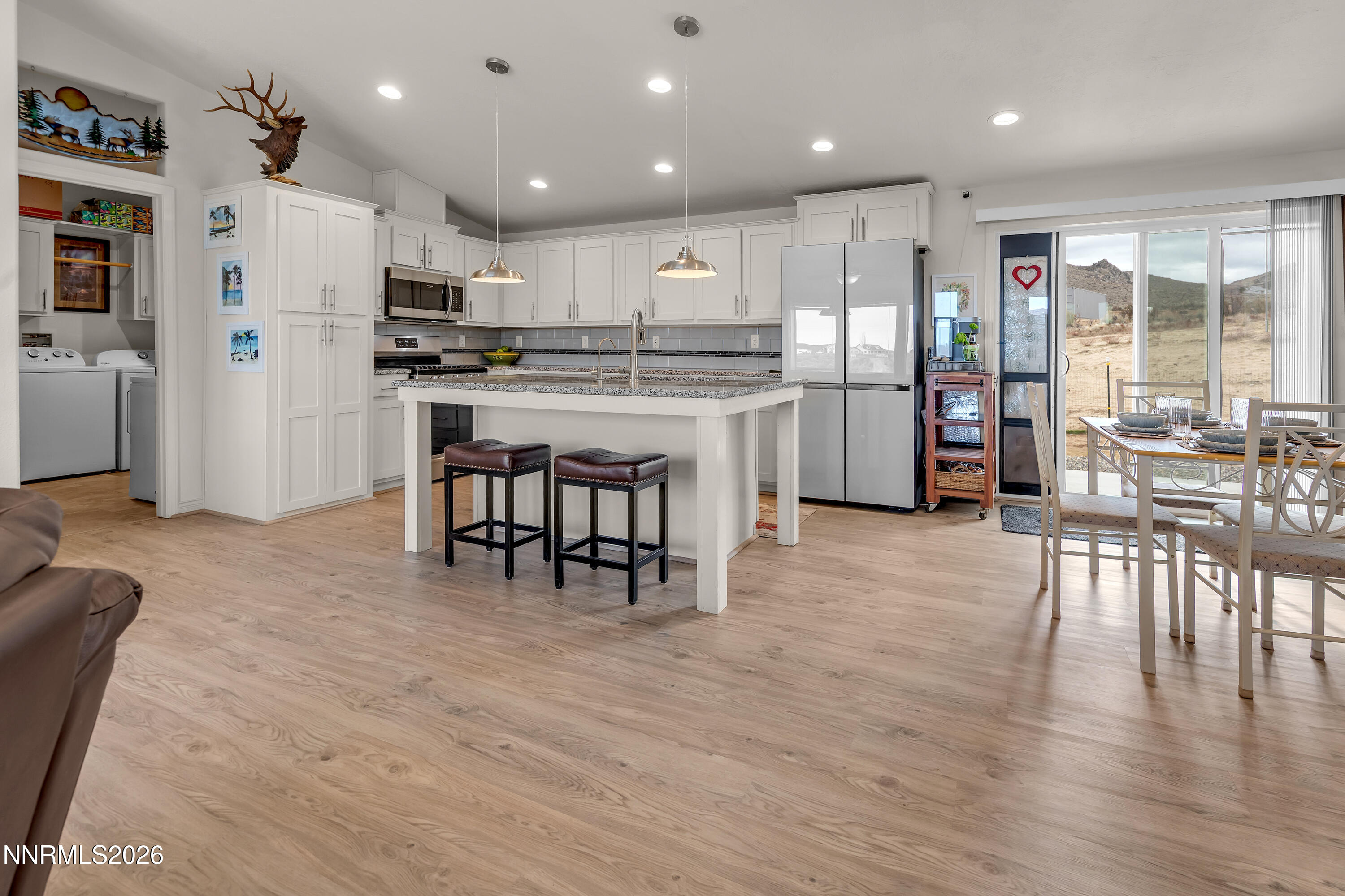 105 Arabian Way Reno, NV 89508 - Photo 9 of 40 a kitchen with white cabinets and stainless steel appliances