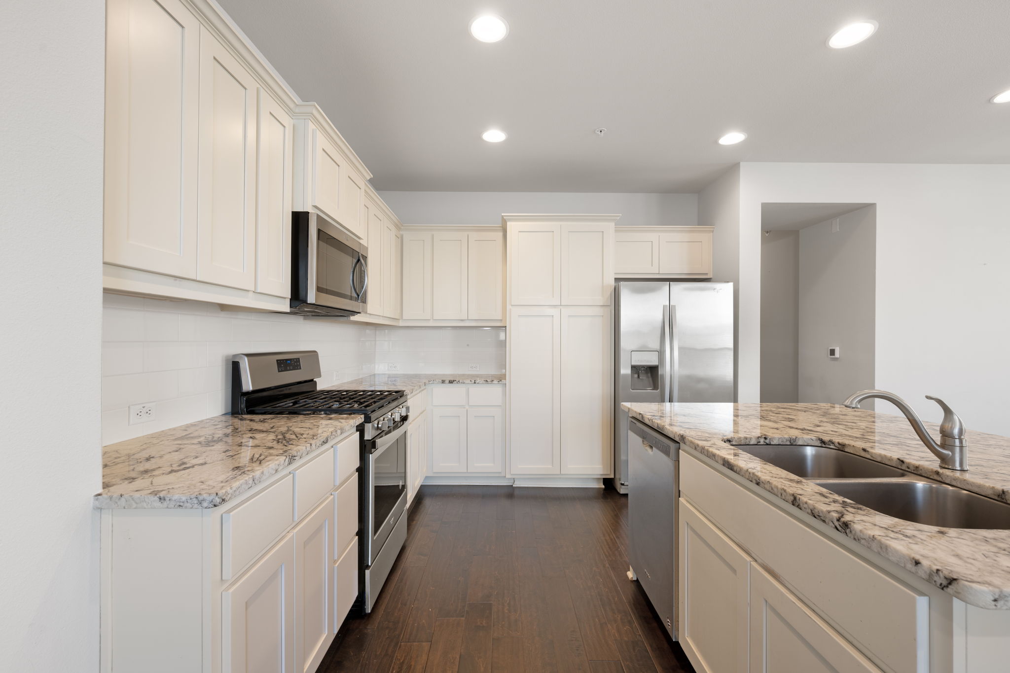 13800 Lyndhurst Street, Unit 326 Austin, TX 78717 - Photo 11 of 39 a kitchen with stainless steel appliances granite countertop a sink stove and refrigerator