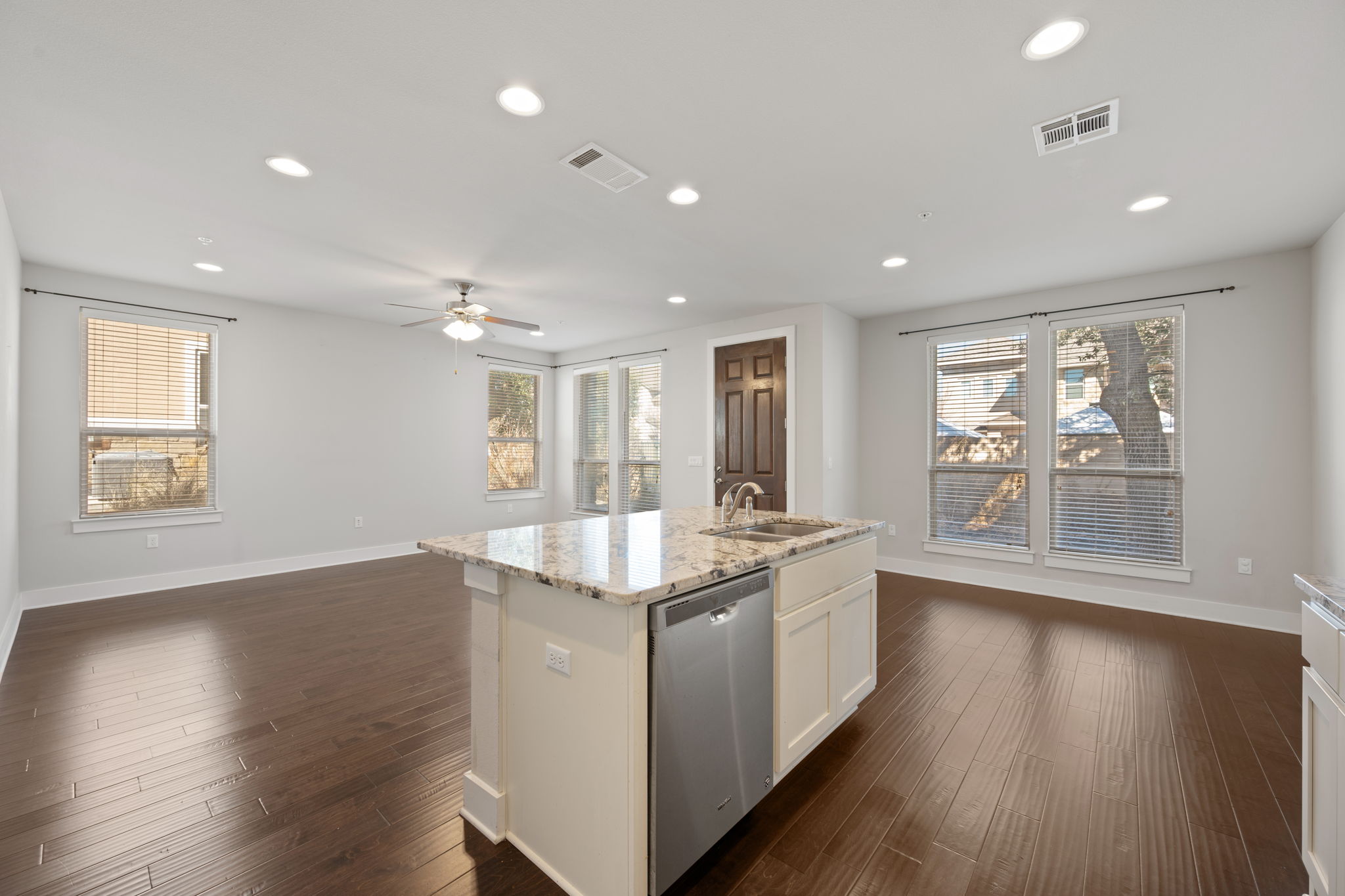 13800 Lyndhurst Street, Unit 326 Austin, TX 78717 - Photo 12 of 39 a large kitchen with stainless steel appliances granite countertop a large center island and a wooden floors