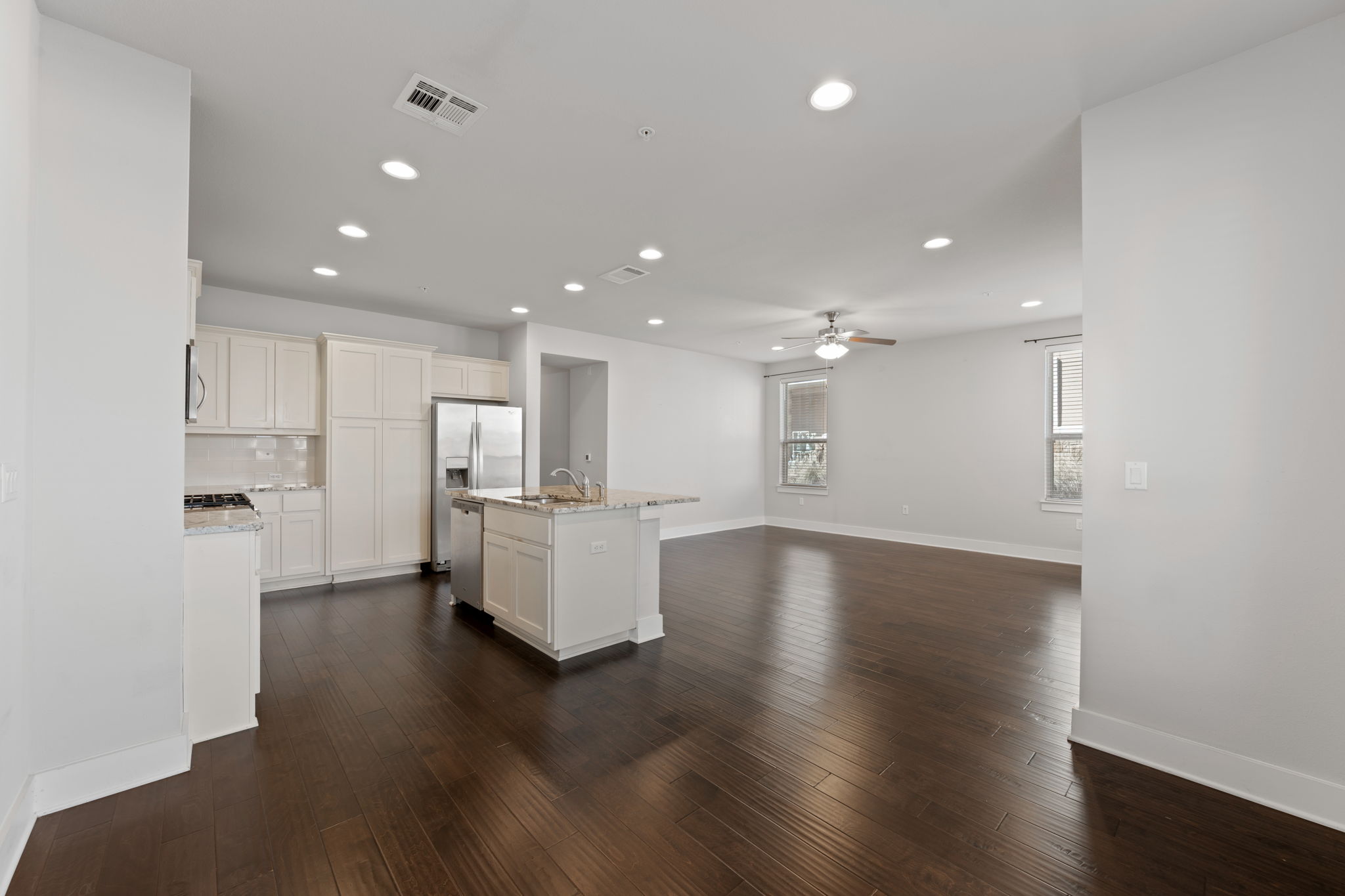 13800 Lyndhurst Street, Unit 326 Austin, TX 78717 - Photo 15 of 39 a view of kitchen with kitchen island refrigerator wooden floor and center island